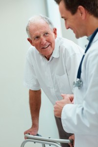 Senior Man using a walker with a male nurse